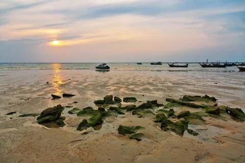 Beach in ebb at sunset Stock Photos