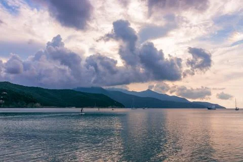 Beach on Elba Island at sunset, beautiful clouds and a calm sea Stock Photos