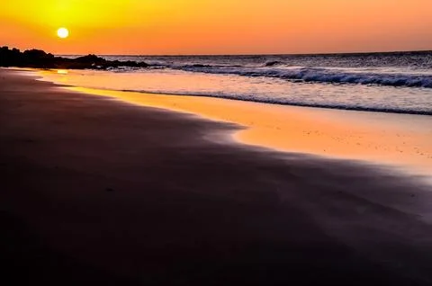The beach is empty and the sun is setting Stock Photos