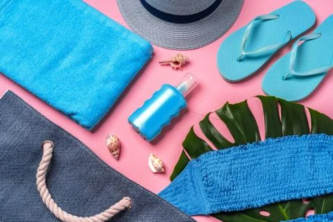 Beach essentials and blue beach bag on pink background 스톡 사진