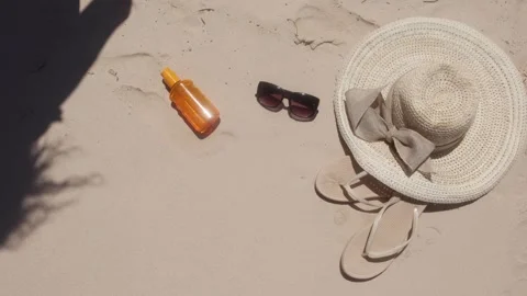 Beach essentials and summer vibes captured during a sunny day on the sandy Stock Footage 306412371