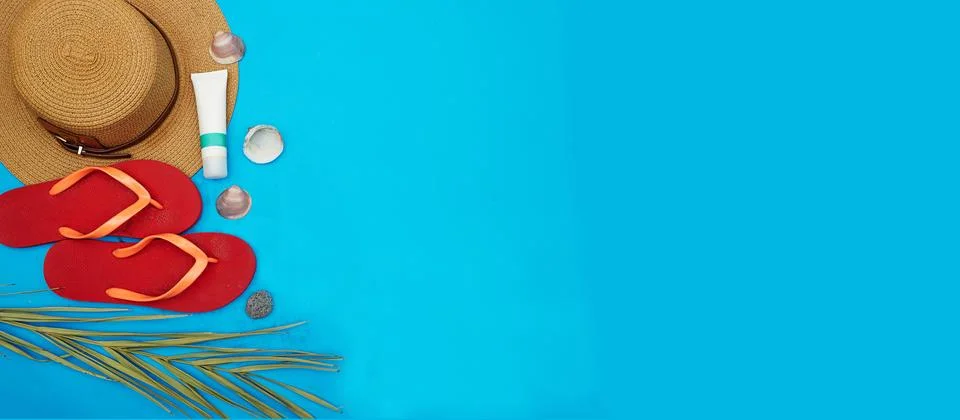 Beach Essentials on blue Background Featuring Hat and Sandals Stock Photos