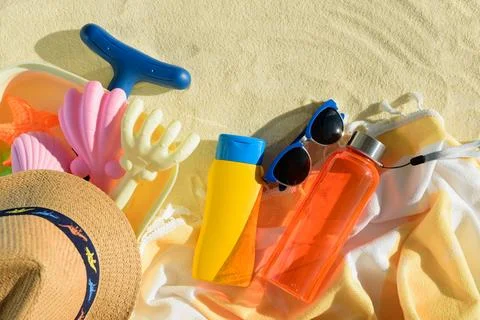 Beach Essentials with Hat, Sunscreen, Water Bottle and Toys. Summer Vacatio.. Stock Photos
