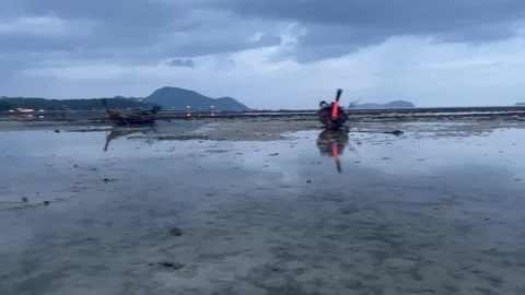 The beach in the evening at low tide with many fishing boats. Stock Footage 231200605