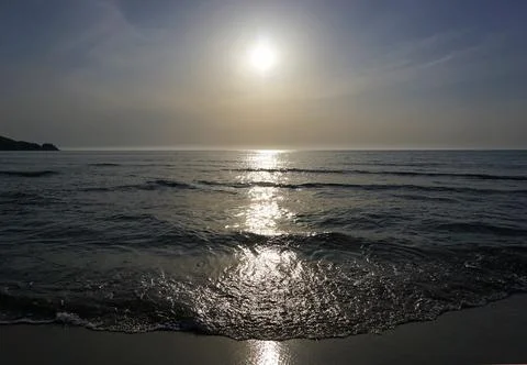 The beach with the evening sun shining in Stock Photos