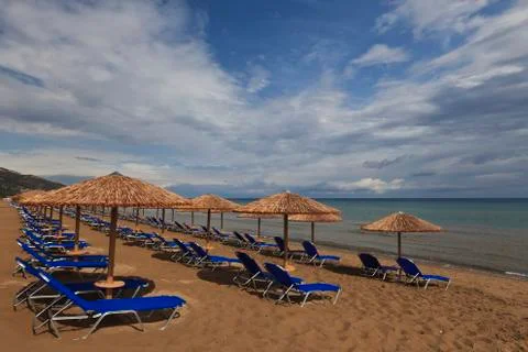 A beach filled with sun beds Stock Photos