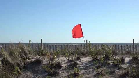 Beach Flag in the wind on a sunny day at Far Rockaway beach in Slow Motion. Stock Footage 132462647