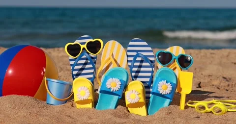 Beach flip-flops on yellow sand against Stock Video Pond5