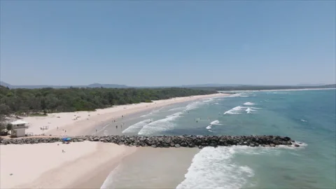 Beach flyover with rock wall Stock Footage 291643360