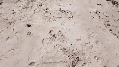 Beach Footprints and Debris Washed Up on Shore Stock Footage 293229774