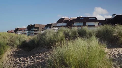 Beach front houses behind dune with grass in Knokke Belgium Stock Footage 329669082