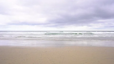 Beach in front of the ocean in California on a cloudy day Stock Footage 154459796