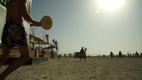 Beach game with a bat and ball in Dubai Stock Footage 104322009