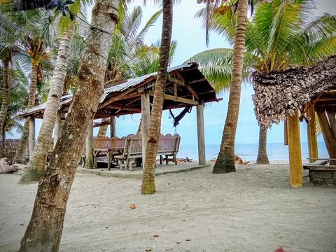 Beach, gazebo, palm trees Stock Photos