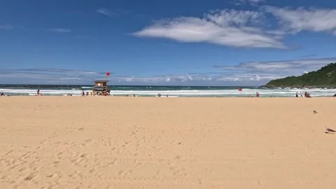 Beach goers enjoy expansive sand beach in sunny San Sebastian, Spain Stock Footage 314366332