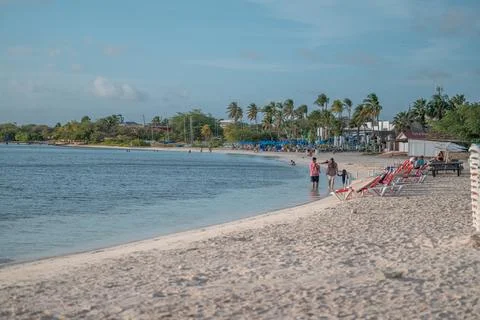 Beach goers at sunset Surfside Beach Aruba Stock Photos