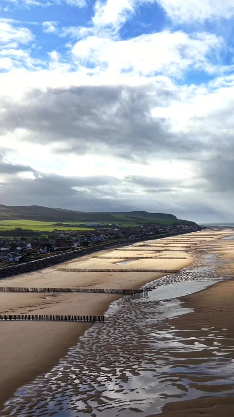 Beach with groynes, sun through clouds, Sangatte, vertical Stock Footage 347178880