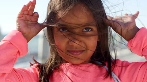 Beach, hand gesture and teasing with playful child on promenade for humor, joke Vídeos de archivo 331581275