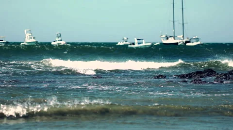 Beach harbor wind blowing white caps off waves coming ashore Stock Footage 61989358