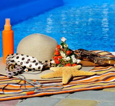 Beach hat, flip flops, head phones, sun spray. Stock Photos