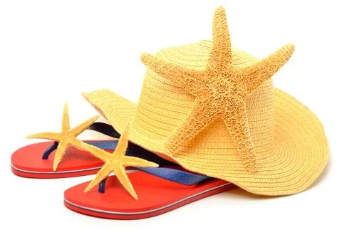 Beach hat, red flip flops with starfishes Stock Photos