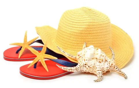 Beach hat, red flip flops with starfishes and a seashell Stock Photos