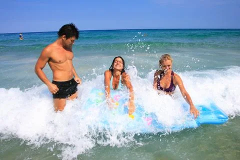 On the beach having lots of fun in their vacation Stock Photos