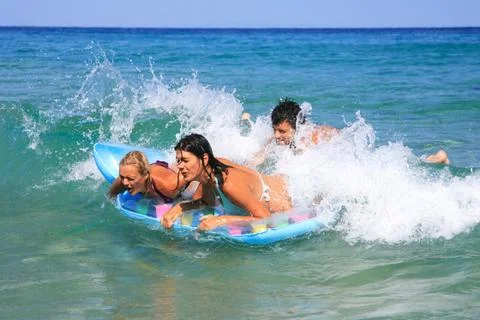 On the beach having lots of fun in their vacation Stock Photos