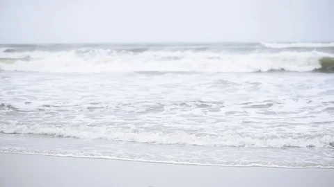 Beach heavy surf tilt up Stock Footage 75770486