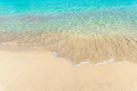 Beach holiday background texture of soft sea water wave on sandy beach Stock Photos