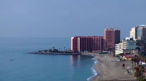 Beach hotel deep blue sky sand waves Stock Footage 48465983