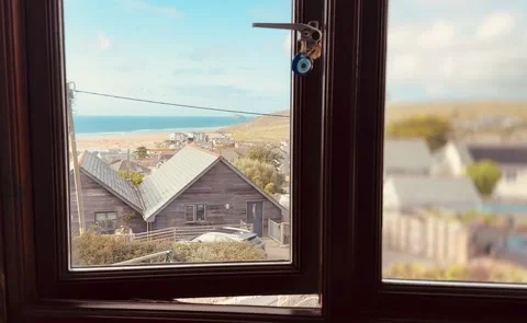 Beach House window and view over a seaside town Stock Footage 282901539