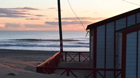 Beach huts framing ocean view at Caparica Video stock 328253320
