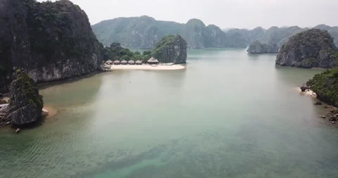 Beach huts in Ha Long Bay Mountains in Vietnam, Aerial Tracking Shot Stockbeeldmateriaal 271080751
