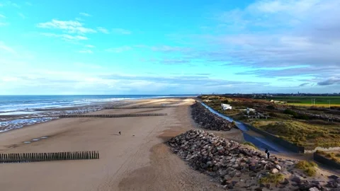 Beach huts, sandy beach and stone sea wall at Sangatte, Opal Coast Stock Footage 347177045