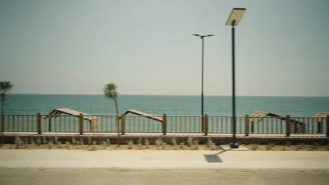 Beach huts by the sea, view from a car moving along the road. Stock Footage 246420039