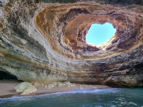 Beach inside a sea cave. Stock Photos