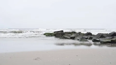 Beach jetty stormy seas overcast Stock Footage 75763723