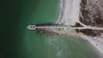 Beach Jetty with Waves Breaking Aerial Birds Eye Drone Shot Видео 85665494