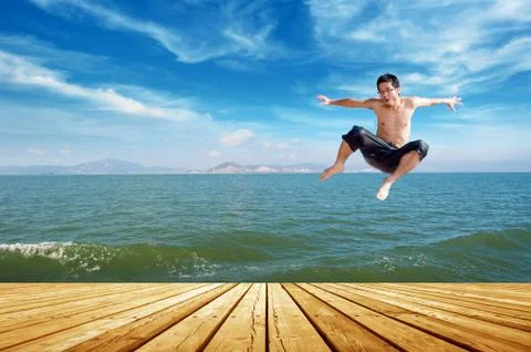 Beach jumping man Stock Photos