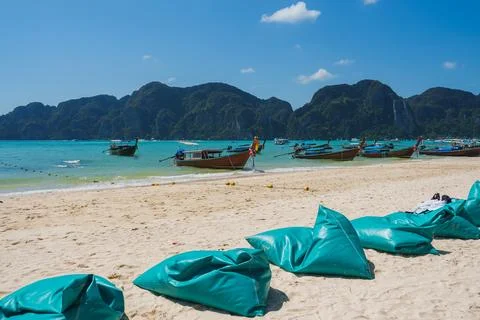 Beach on Koh Phi Phi with Longtail Boats and Limestone Cliffs Stock Photos