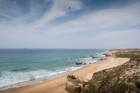 Beach landscape with waves and cliffs Stock Photos