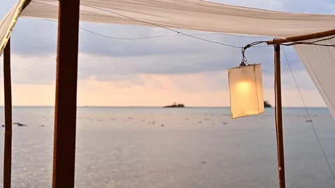 Beach lantern lamp is hanging on cable with lightbulb. Stock Footage 129681728