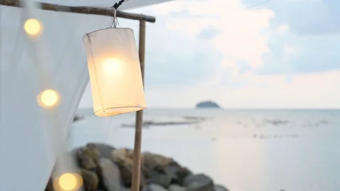 Beach lantern lamp is hanging on cable with lightbulb. Stock Footage 129681759