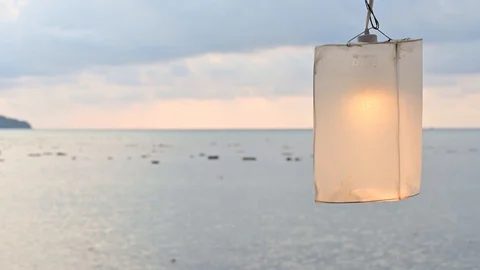 Beach lantern lamp is hanging on cable with lightbulb. Stock Footage 129681810