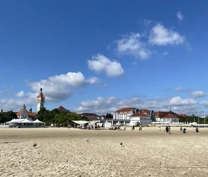 A beach with a large building in the background Stock Photos