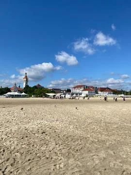 A beach with a large building in the background Stock Photos