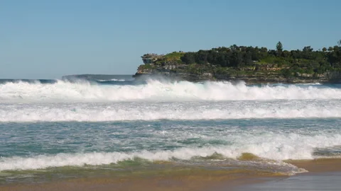 Beach with large waves and distant cliff Stock Footage 298341860
