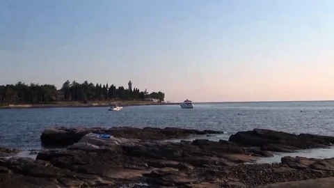 Beach in the late afternoon with lighthouse in the background Stock Footage 69123648