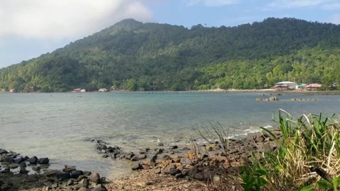 Beach on Lemukutan Island with a mountain backdrop Stock Footage 312657969